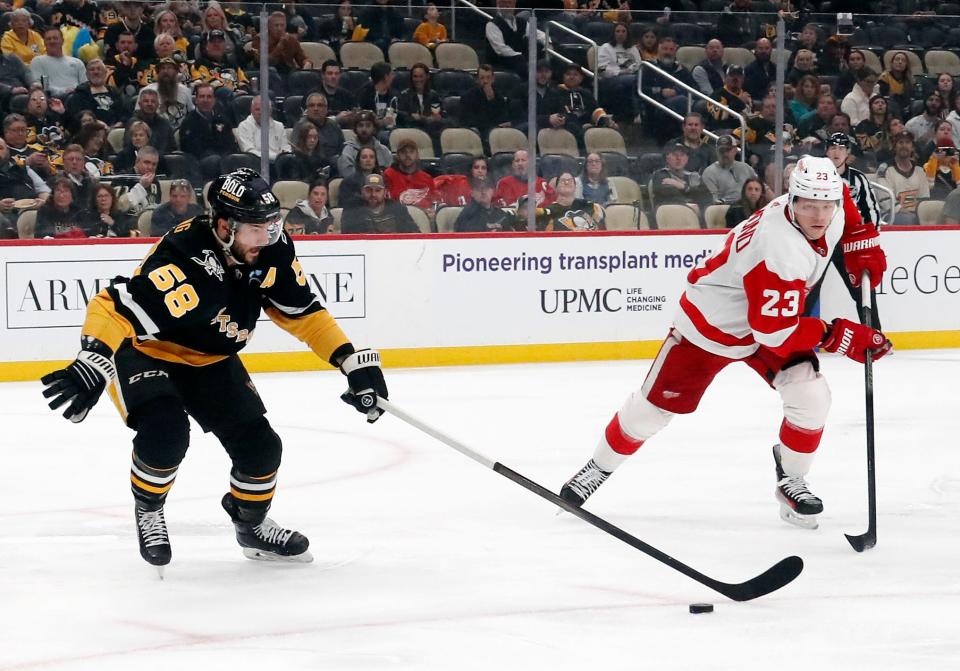 Penguins defenseman Kris Letang moves the puck against Red Wings left wing Lucas Raymond during the first period on Thursday, April 11, 2024, in Pittsburgh.