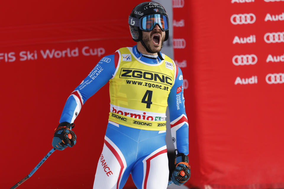 France's Cyprien Sarrazin celebrates at the finish area of an alpine ski, men's World Cup downhill race, in Bormio, Italy, Thursday, Dec. 28, 2023. (AP Photo/Alessandro Trovati)