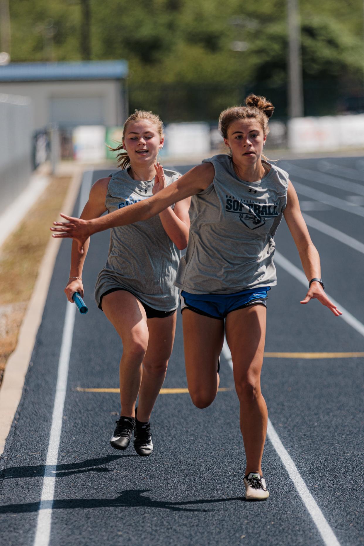 Morgan Wasemiller (left) and Campbell Barta practice their hand-off on Wednesday.