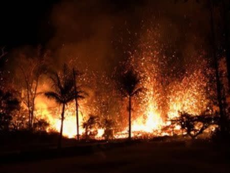 A new fissure spraying lava fountains as high as about 230 feet (70 m), according to United States Geological Survey, is shown from Luana Street in Leilani Estates subdivision on Kilauea Volcano's lower East Rift Zone in Hawaii, U.S., May 5, 2018. Photo taken May 5, 2018. US Geological Survey/Handout via REUTERS