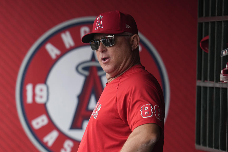 Los Angeles Angels manager Phil Nevin watches from the dugout during the first inning in the first baseball game of a doubleheader against the Tampa Bay Rays, Saturday, Aug. 19, 2023, in Anaheim, Calif. (AP Photo/Marcio Jose Sanchez)