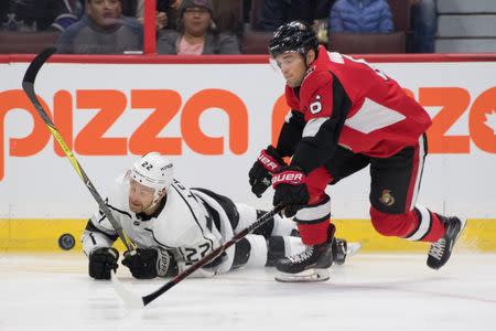 Oct 13, 2018; Ottawa, Ontario, CAN; Los Angeles King center Trevor Lewis (22) and Ottawa Senators defenseman Chris Wideman (6) battle in the first period at Canadian Tire Centre. Mandatory Credit: Marc DesRosiers-USA TODAY Sports