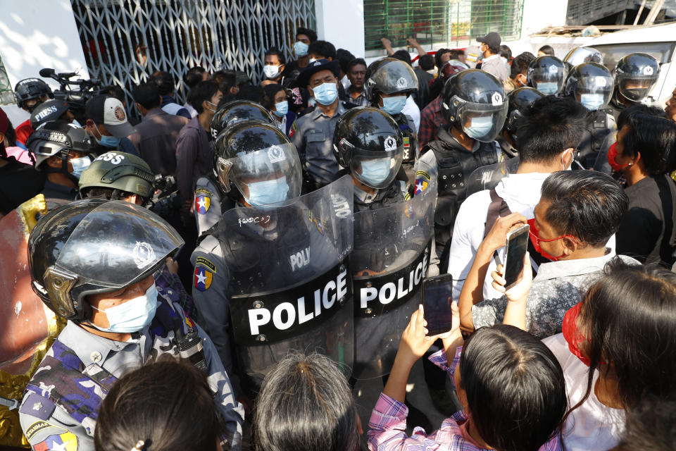 Residents and protesters face riot police as they question them about recent arrests made in Mandalay, Myanmar, Saturday, Feb. 13, 2021. Daily rallies against the coup occurring in Myanmar's two largest cities, Yangon and Mandalay, enter its second week despite a ban on public gatherings of five or more. (AP Photo)