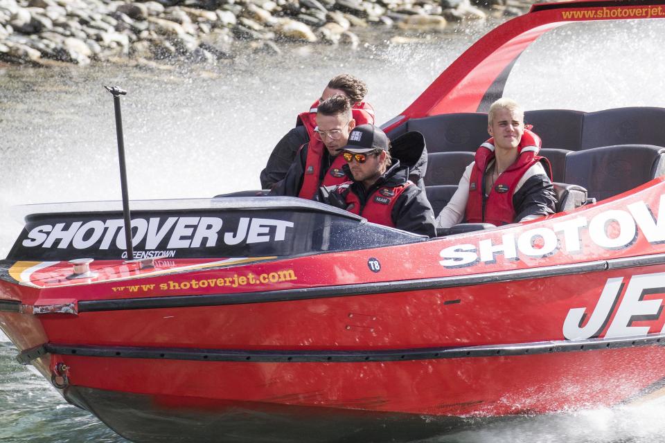 Biebs boards a boat and looks, well bored...