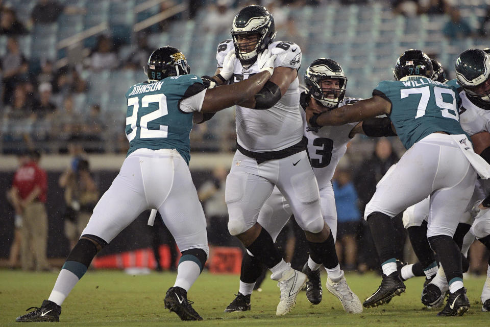 FILE - In this Aug. 15, 2019, file photo, Philadelphia Eagles offensive tackle Jordan Mailata (68) and center Anthony Fabiano (63) block against Jacksonville Jaguars defensive end Lyndon Johnson (92) and defensive tackle Andrew Williams (79) during the second half of an NFL preseason football game in Jacksonville, Fla. The 6-foot-8, 346-pound Mailata has come a long way in a short time and fared well in his first career start protecting Carson Wentz's blind side before a national audience on Sunday Night Football in Philadelphia's 25-20 win at San Francisco, on Oct. 4, 2020.(AP Photo/Phelan M. Ebenhack, FIle)