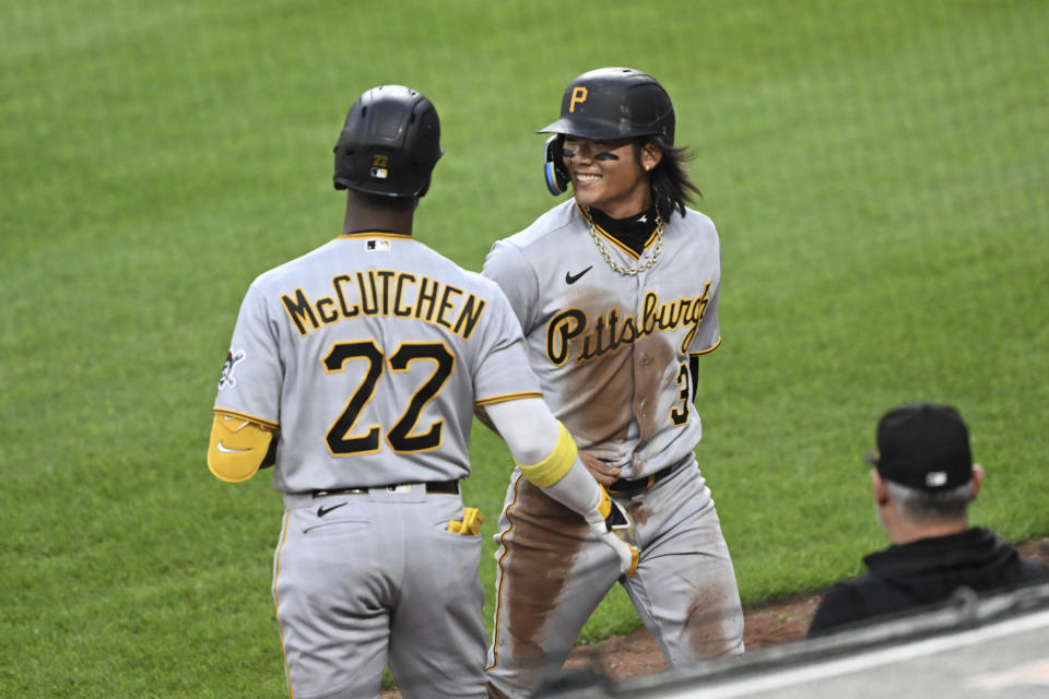 CORRECTS SPELLING TO BAE, INSTEAD OF BANE - Pittsburgh Pirates Ji Hwan Bae, right, is congratulated by Andrew McCutchen after scoring against the Baltimore Orioles during the third inning of a baseball game Friday, May 12, 2023, in Baltimore. (AP Photo/Gail Burton)