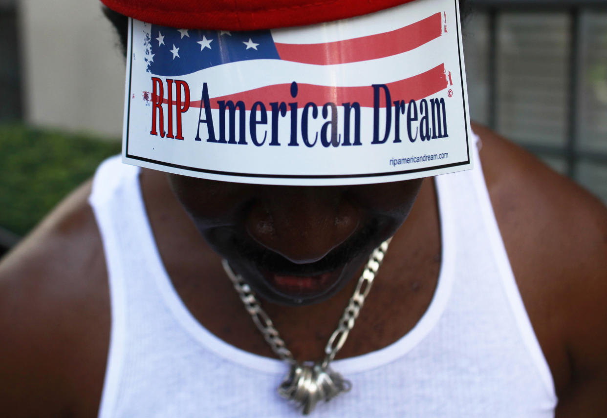 A member of Occupy Wall Street protesting on 5th Avenue in October 2011. A new report has found racial inequality has worsened over the last 50 years. (Photo: Shannon Stapleton / Reuters)