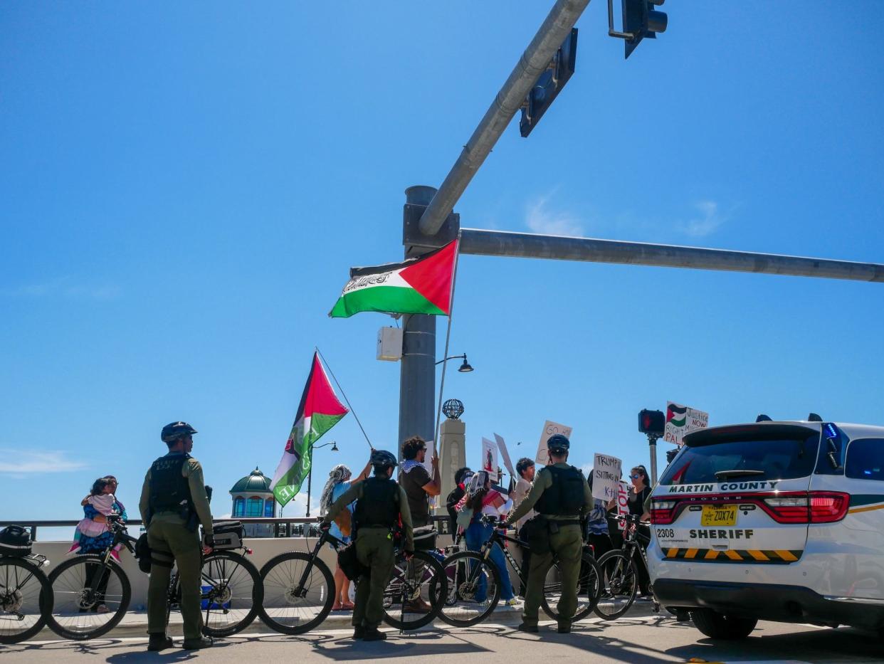 Pro-Palestine protesters stand on the Southern Boulevard Bridge on Friday morning ahead of Israeli Prime Minister Benjamin Netanyahu's meeting with former President Donald Trump at Mar-a-Lago in Palm Beach.