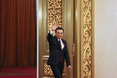 China's Premier Li Keqiang waves as he arrives at a news conference following the closing ceremony of China's National People's Congress (NPC) at the Great Hall of the People in Beijing, China, March 16, 2016. REUTERS/Damir Sagolj