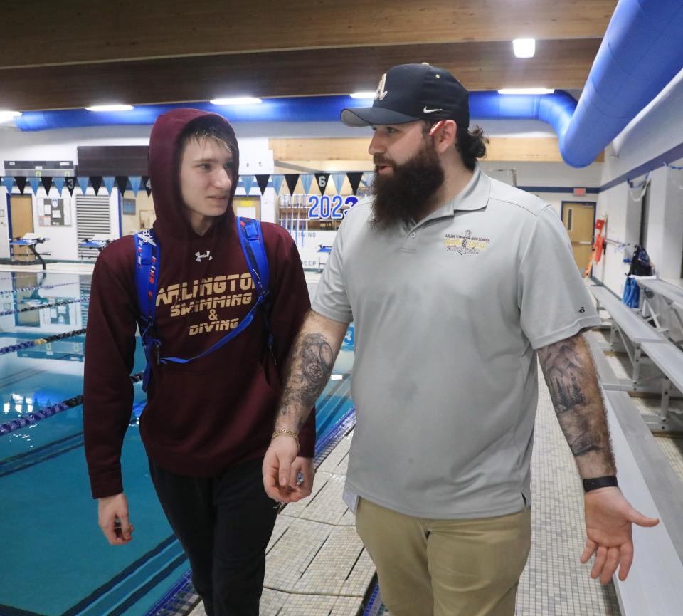Jacob and Alec Cerrato after Tuesday's meet on January 24, 2023. Alec coaches his brother Jacob on the Arlington swimming team. 