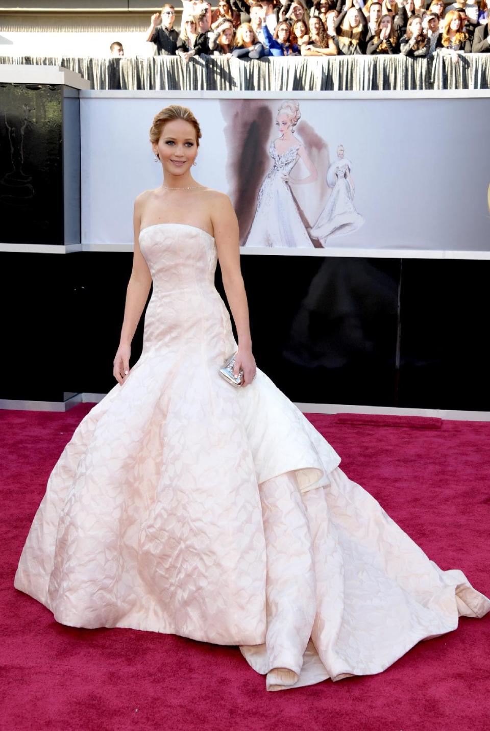 FILE - This Feb. 24, 2013 file photo shows actress Jennifer Lawrence at the 85th Academy Awards at the Dolby Theatre in Los Angeles. Prom season provides many girls a chance to have their moment in the spotlight. It's likely that this year's parade of fashions will include a few celebrity lookalikes. (Photo by John Shearer/Invision/AP, file)