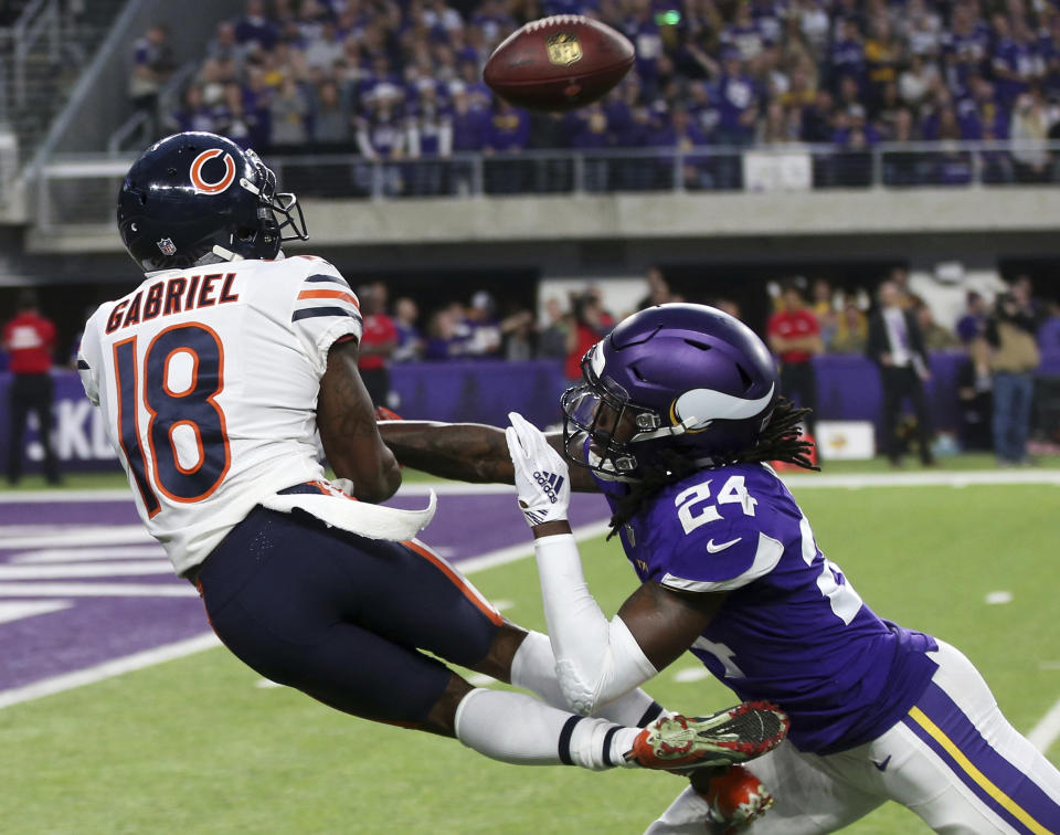 Chicago Bears wide receiver Taylor Gabriel (18) catches a pass over Minnesota Vikings defensive back Holton Hill (24) during the first half of an NFL football game, Sunday, Dec. 30, 2018, in Minneapolis. (AP Photo/Jim Mone)