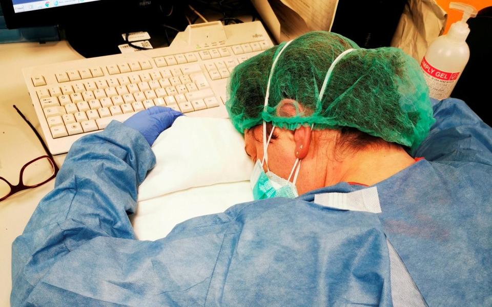 The photo of Elena Pagliarini slumped on a hospital desk, exhausted from caring for patients, became a symbol of Italy's long battle with the virus - Francesca Mangiatordi/Reuters