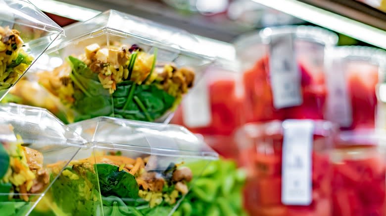 pre-packaged salads on a shelf in the store