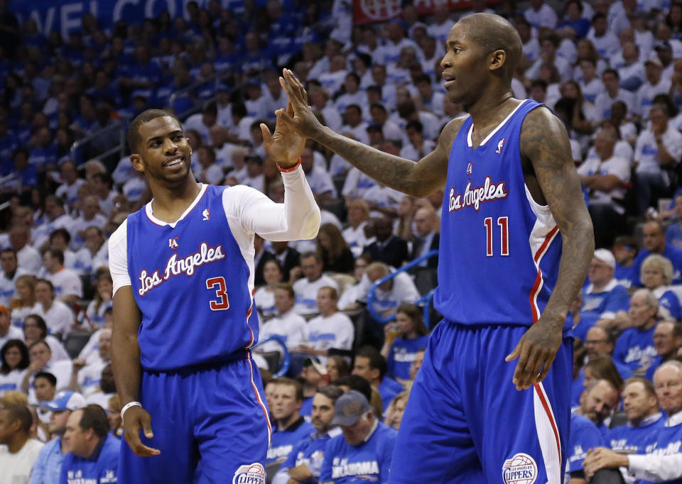 Los Angeles Clippers guard Chris Paul (3) high fives teammate Jamal Crawford (11) in the second quarter of Game 2 of the Western Conference semifinal NBA basketball playoff series against the Oklahoma City Thunder in Oklahoma City, Wednesday, May 7, 2014. (AP Photo/Sue Ogrocki)