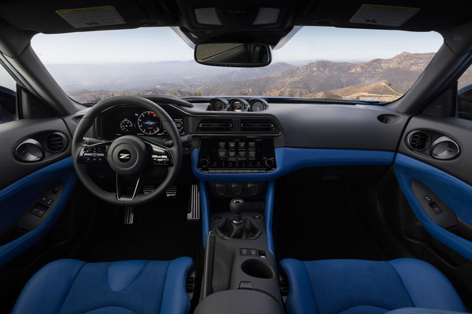 The interior of the new 2023 Nissan Z, featuring analog pod gauges, a new digital meter display and even a good ol' handbrake. The sports car was unveiled in August 2021.