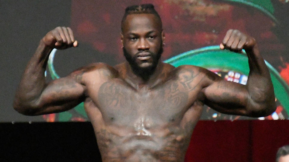 Deontay Wilder is is pictured here posing at the weigh-in for the Tyson Fury fight.