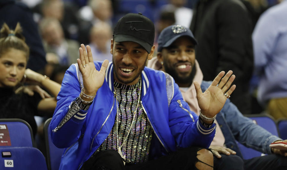 Arsenal player Pierre-Emerick Aubameyang gestures as he attends a NBA basketball game between New York Knicks and Washington Wizards at the O2 Arena, in London, Thursday, Jan.17, 2019. (AP Photo/Alastair Grant)