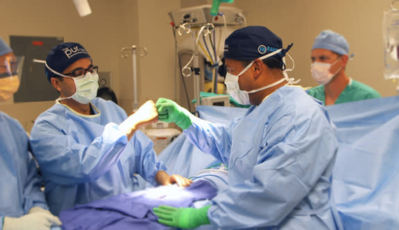 Dr. Jamin Brahmbhatt and Dr. Sijo Parekattil congratulate each other after a successful procedure at the PUR Clinic in Clermont, Fl. The two will leave the OR for nine days in June to drive cross-country to urge men to make their health a prior