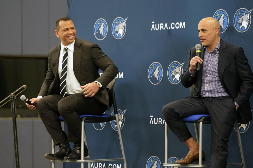 Minnesota Timberwolves new owners Marc Lore, right, and baseball great Alex Rodriguez, left, address the media after current owner Glen Taylor introduced them during a news conference for the NBA Timberwolves basketball team, Monday, Sept. 27, 2021, in Minneapolis. (AP Photo/Jim Mone)