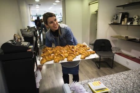 Allyn Bonnenfant, a member of the French community, carries a tray of croissants in her patisserie in Netanya, a city of 180,000 on the Mediterranean north of Tel Aviv, that has become the semi-official capital of the French community in Israel January 25, 2015. REUTERS/Ronen Zvulun