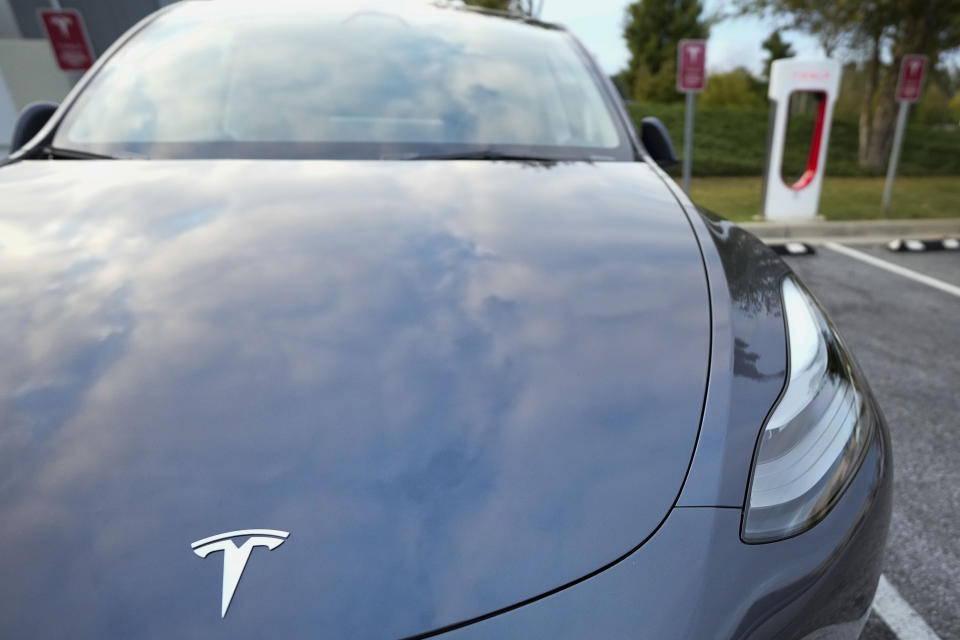 File - A Tesla Model Y Long Range charges, Sept. 27, 2023, in Woodstock, Ga. Government tallies show only 11 of the more than 50 EVs on sale in the U.S. are eligible for tax credits so far this year. Still qualifying for credits are the Tesla Model Y SUV, Chevrolet Bolt compact car and Rivian R1T pickup truck. (AP Photo/Mike Stewart, File)