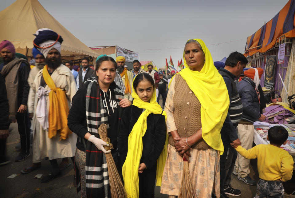 Manjeet Kaur, 60, right, poses for a photograph with her grand daughters as they arrive to give their support during a protest against new farm laws at the Delhi-Haryana state border, on the outskirts of New Delhi, India, Sunday, Dec. 27, 2020. From students, teachers and nurses to housewives and grandmothers, women are now holding the front lines at the massive protests that have blockaded key highways leading to India's capital for more than a month, demanding the repeal of new farm laws. (AP Photo/Manish Swarup)