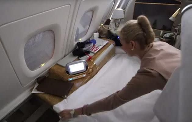 Casey attempts to make up his own bed, before a flight attendant insists on doing it for him. Image: Youtube/CaseyNeistat