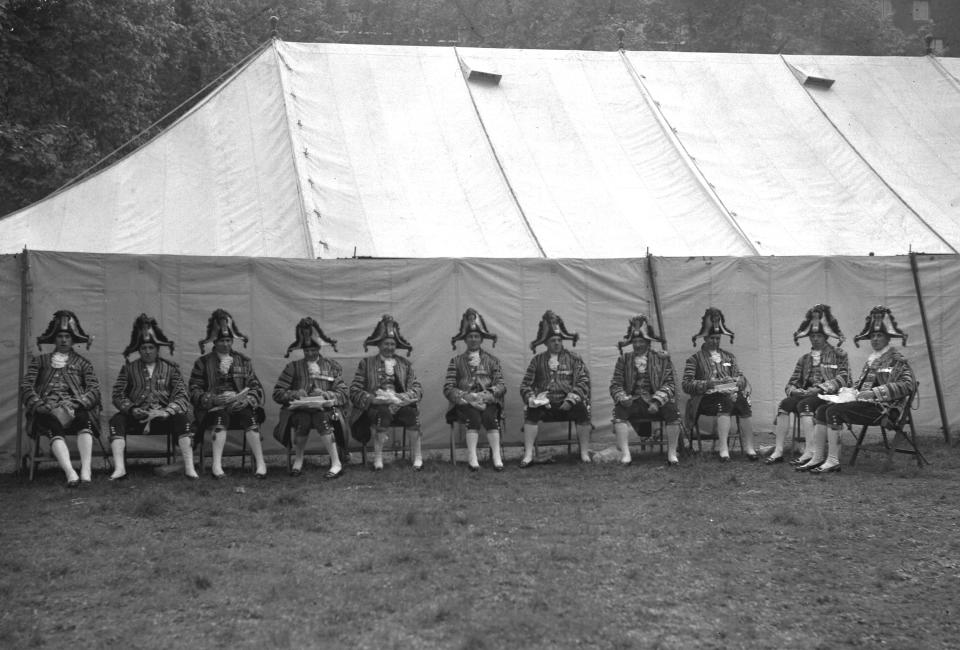 FILE - Coachmen eat lunch on the grounds of Westminster Abbey during the coronation of Britain's Queen Elizabeth II. London, Jun. 2, 1953. The Associated Press will muster a small army to cover King Charles III's coronation this weekend. For his mother's crowning 70 years ago, the wire service also enlisted the help of an air force. In 1953, it took eight minutes to transmit a single black-and-white photograph, provided the weather conditions and phone lines cooperated. So among the methods AP employed to deliver photos from London to its American newspaper clients was an arrangement to put them on Royal Air Force bombers. (AP Photo, file)