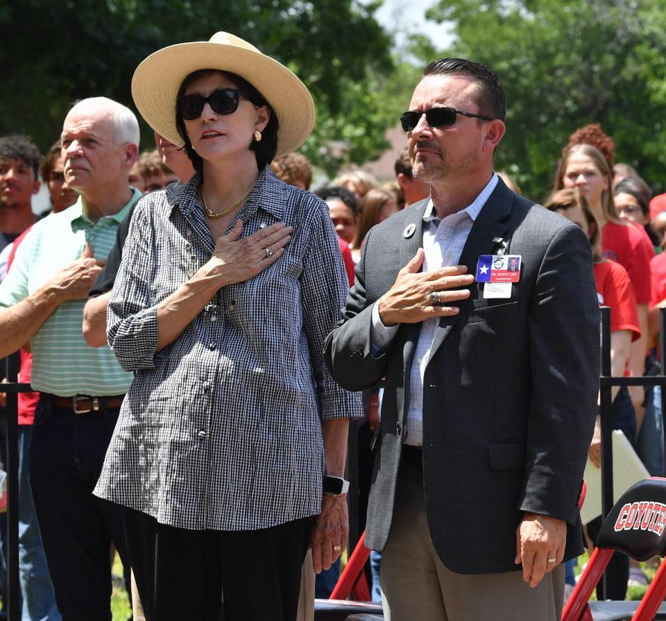 Dr. Donny Lee, Wichita Falls ISD superintendent, (right), School Board President Katherine McGregor, (middle), and Place 3 Trustee Mark Lukert stand for the national anthem during the closing ceremony for Wichita Falls High School on May 15.