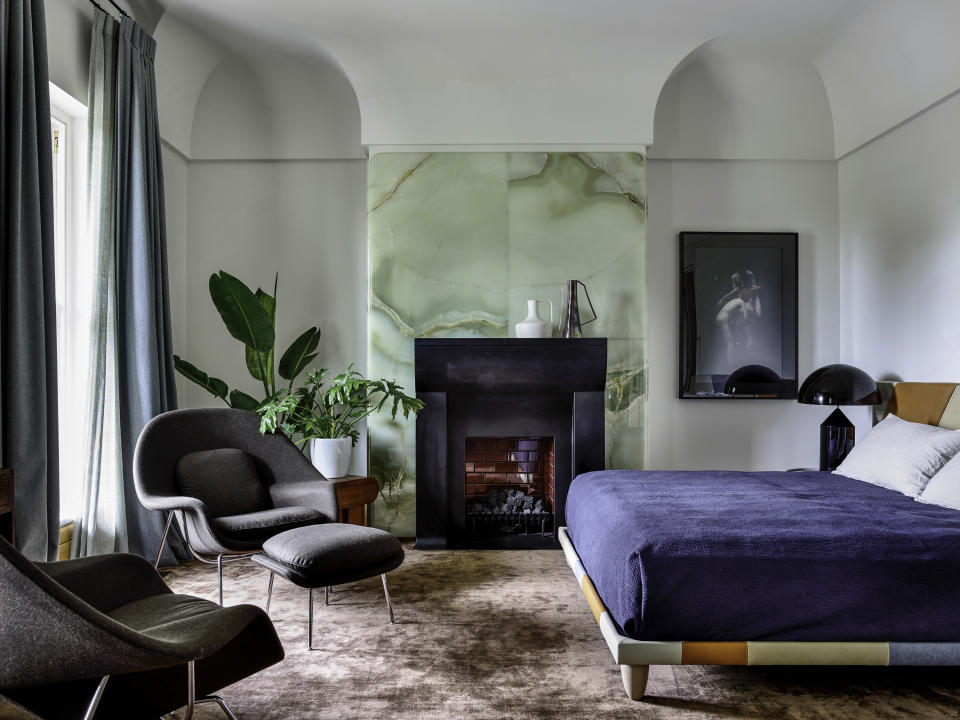 A bedroom with a onyx fireplace