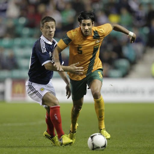 Ian Black (L) of Scotland vies with Rhys Williams (R) of Australia during the international friendly football match at Easter Road Stadium in Edinburgh, Scotland. Scotland won 3-1 over Australia