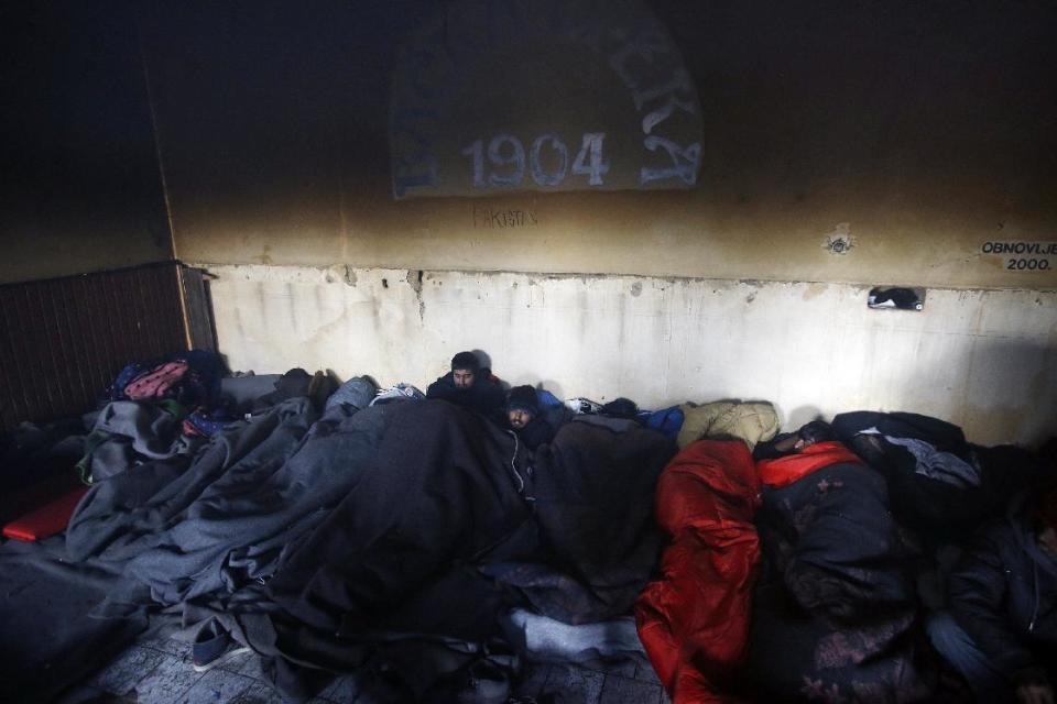 Migrants covered with blankets rest in an abandoned brick factory in the northern Serbian town of Subotica, near the border between Serbia and Hungary, Wednesday, Feb. 1, 2017. Thousands of migrants have been stranded in Serbia and looking for ways to cross illegally into the European Union. (AP Photo/Darko Vojinovic)