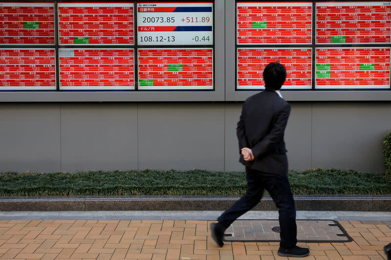 A man looks at an electronic board showing the Nikkei stock index outside a brokerage in Tokyo, Japan, January 7, 2019. REUTERS/Kim Kyung-Hoon