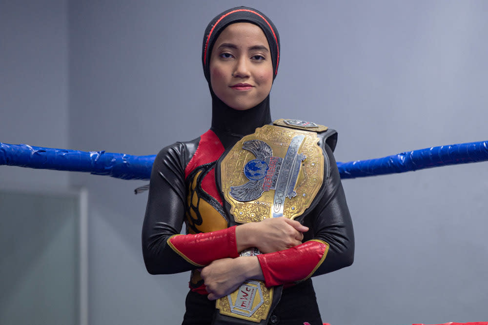 Nor ‘Phoenix’ Diana strikes a pose with her Wrestlecon Championship belt. — Picture by Mukhriz Hazim