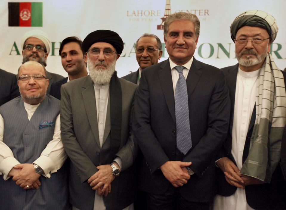 Afghan politicians and other participants pose for photograph with Pakistani Foreign Minister Shah Mahmood Qureshi, second right, after the opening session of an Afghan Peace Conference in Bhurban, 65 kilometers (40 miles) north of Islamabad, Pakistan, Saturday, June 22, 2019. Dozens of Afghan political leaders attended a peace conference in neighboring Pakistan on Saturday to pave the way for further Afghan-to-Afghan dialogue. (AP Photo/Anjum Naveed)