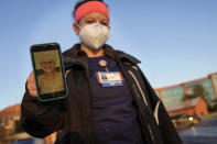 Nurse Jessica Franz, shows a photo of her mother-in-law, Elaine Franz, outside Olathe Medical Center after working the graveyard shift Thursday, Nov. 26, 2020, in Olathe, Kan. Elaine Franz died Nov. 10, one day before her 78th birthday, after contracting COVID-19. (AP Photo/Charlie Riedel)