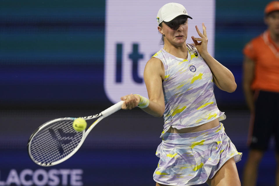 Iga Swiatek, of Poland, hits a forehand to Jessica Pegula during the Miami Open tennis tournament Thursday, March 31, 2022, in Miami Gardens, Fla. (AP Photo/Marta Lavandier)