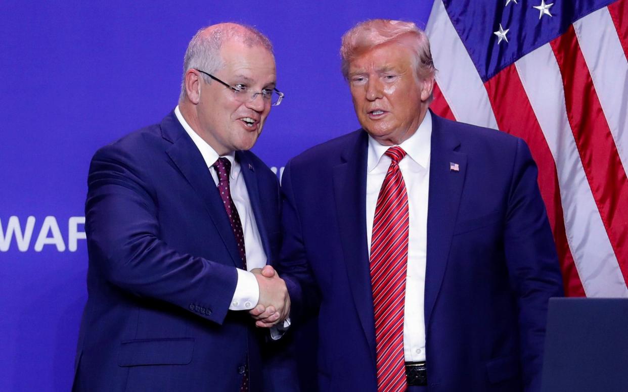 President Donald Trump and Australian Prime Minister Scott Morrison shake hands  - AP