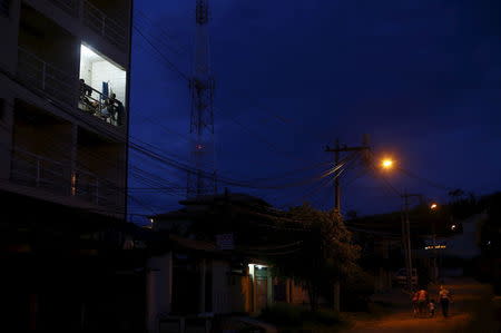 Laid-off workers of Comperj are pictured on the balcony of the Pousada do Trabalhador (Workers Inn), which closed down after the scandal involving Petrobras, on its last day of operations, in Itaborai March 31, 2015. REUTERS/Ricardo Moraes