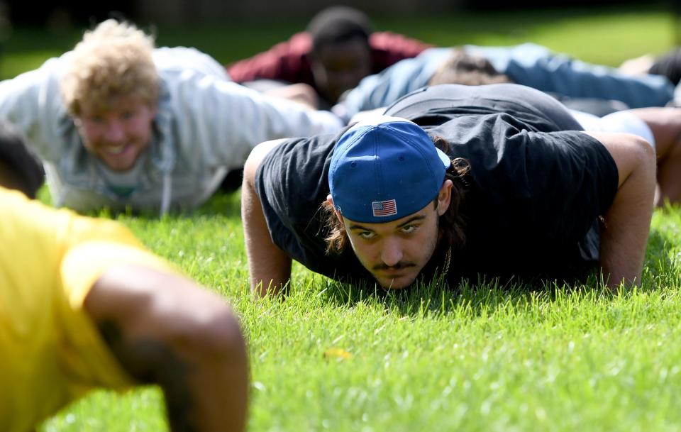 Walsh University student Chandler Stevens was among those who performed 22 pushups Thursday at an event designed to increase awareness of veteran deaths from suicide. Active-duty military members and Walsh students, faculty and staff participated in the activity.