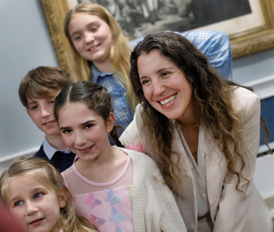 Braintree Mayor Erin Joyce poses for photos with young residents at her swearing-in ceremony Tuesday, Jan. 2, 2024, at town hall.
