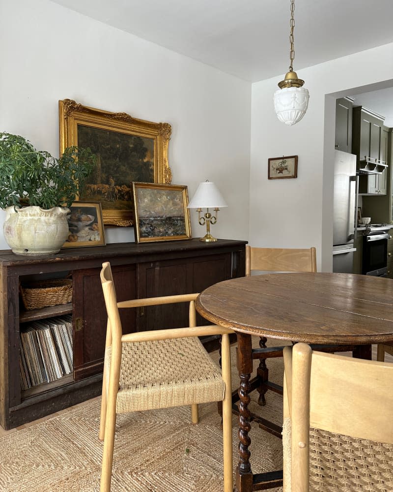 Round wooden dining table in newly renovated dining room.