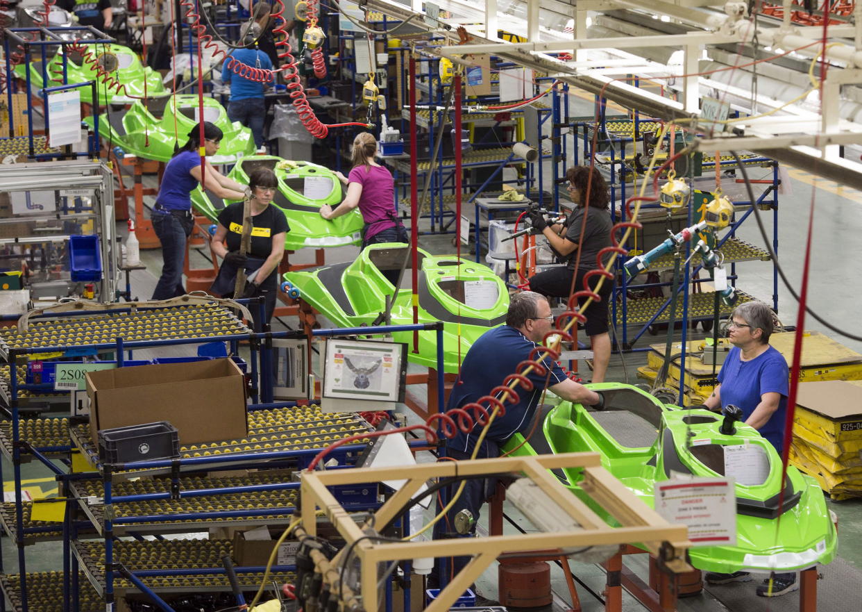 Employees work on the SeaDoo assembly line at the Bombardier Recreational Products (BRP) plant Thursday, June 12, 2014 in Valcourt, Quebec. THE CANADIAN PRESS/Ryan Remiorz