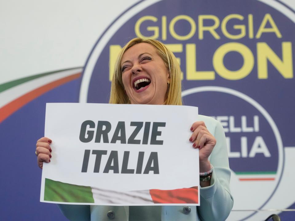 Far-Right party Brothers of Italy's leader Giorgia Meloni shows a placard reading in Italian "Thank you Italy" at her party's electoral headquarters in Rome, early Monday, Sept. 26, 2022.