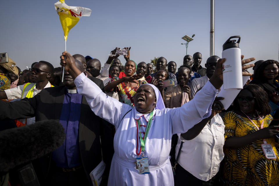 A nun in the crowd shouts that the country needs peace as Pope Francis prepares to leave in his vehicle from the airport in Juba, South Sudan Friday, Feb. 3, 2023. Pope Francis arrived in South Sudan on the second leg of a six-day trip that started in Congo, hoping to bring comfort and encouragement to two countries that have been riven by poverty, conflicts and what he calls a "colonialist mentality" that has exploited Africa for centuries. (AP Photo/Ben Curtis)