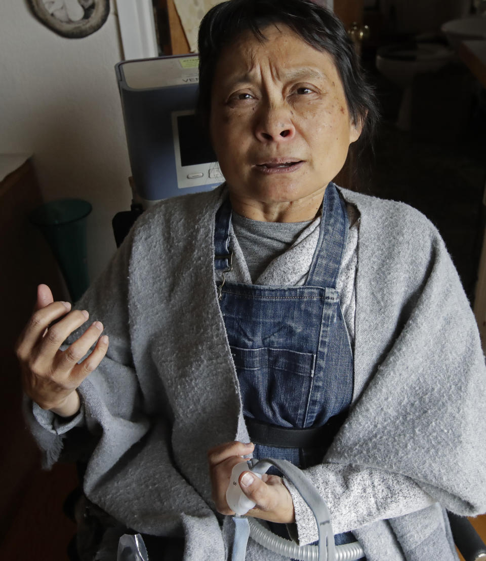 HOLD FOR STORY: In this photo taken on Monday, Dec. 2, 2019, Grace Lin gestures while speaking at her home in El Cerrito, Calif. An Associated Press review reveals persistent problems during four smaller shutoffs that Pacific Gas & Electric did starting last year so power lines downed by strong winds wouldn’t spark wildfires. “PG&E did nothing to help us who depend on electricity to run our life support,” recounted Lin, a polio survivor who needs a ventilator to breathe and uses an electric wheelchair. “It’s not like we could simply grind our teeth and tough it out by holding our breath.”(AP Photo/Ben Margot)