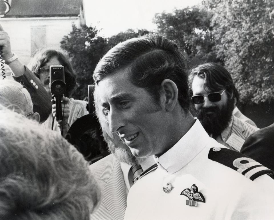 Members of the media surround Prince Charles as he arrives at Strawbery Banke for a reception in honor of Portsmouth's 350th anniversary.