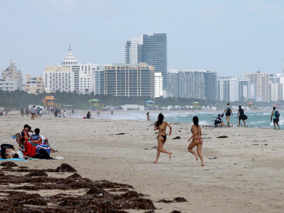 Beachgoers in Miami Beach, Florida, as tropical storm Nicole approaches the state