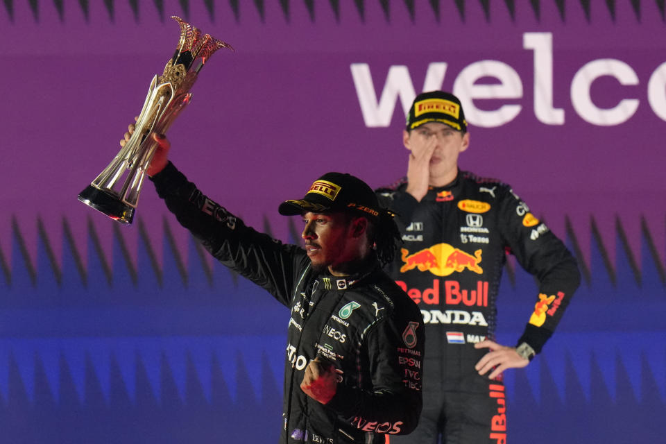 Mercedes driver Lewis Hamilton of Britain celebrates winning the Formula One Saudi Arabian Grand Prix in front of the second placed Red Bull driver Max Verstappen of the Netherlands, in Jiddah, Sunday, Dec. 5, 2021. (AP Photo/Hassan Ammar)